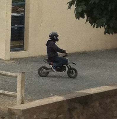 He's a teenager. The "scooter" looks like it's built for a 4-year-old.